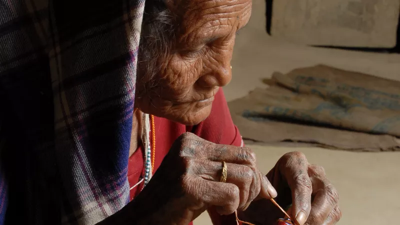 Nepalese woman making traditional basket