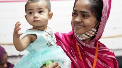 Portrait of Bangladeshi garment worker and her child