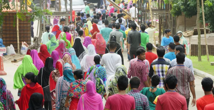 Workers from a readymade garment factory in Bangladesh are seen leaving work at the end of the work day