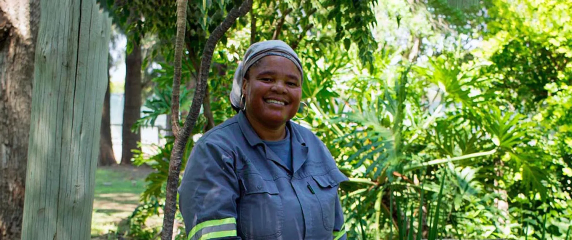 A female gardener stands in a garden in Botswana