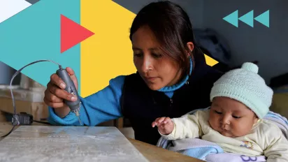 Mother carving tombstones while taking care of her baby, Bolivia