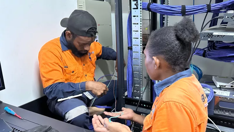 Cabling engineer fixing fiber optic cable at the customer site, in Papua New Guinea.