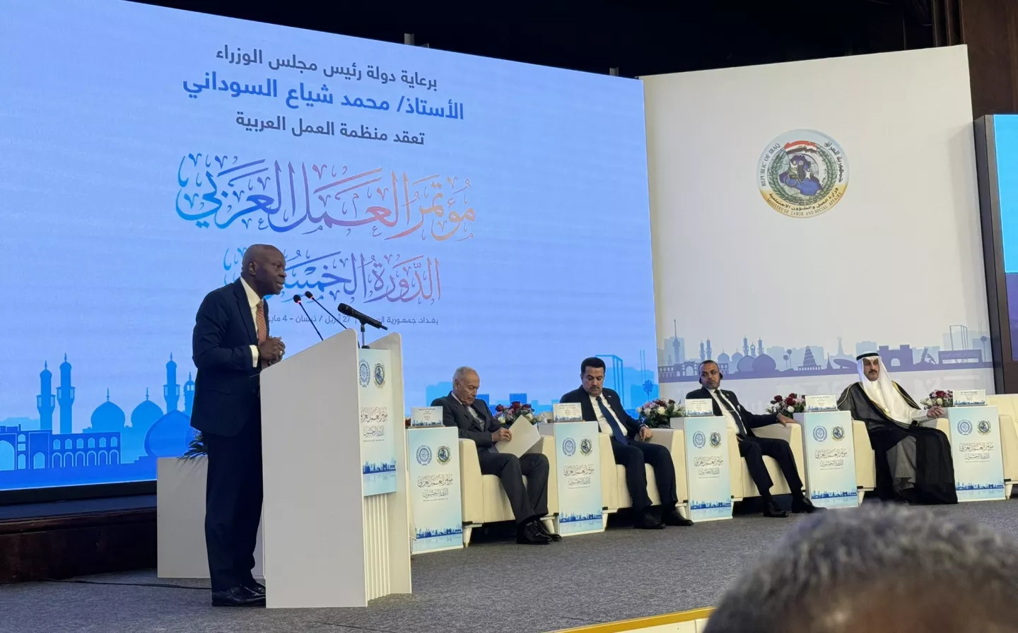 a man giving a speech on a stage