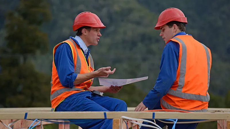 Electricians discuss the construction plan near Greymouth, New Zealand