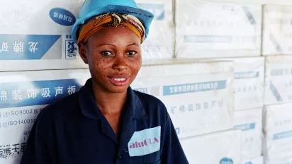 Better jobs for women: for 1 US$ a day, Grace cleans the windows of a building under construction on the seaside of Dar Es Salaam.