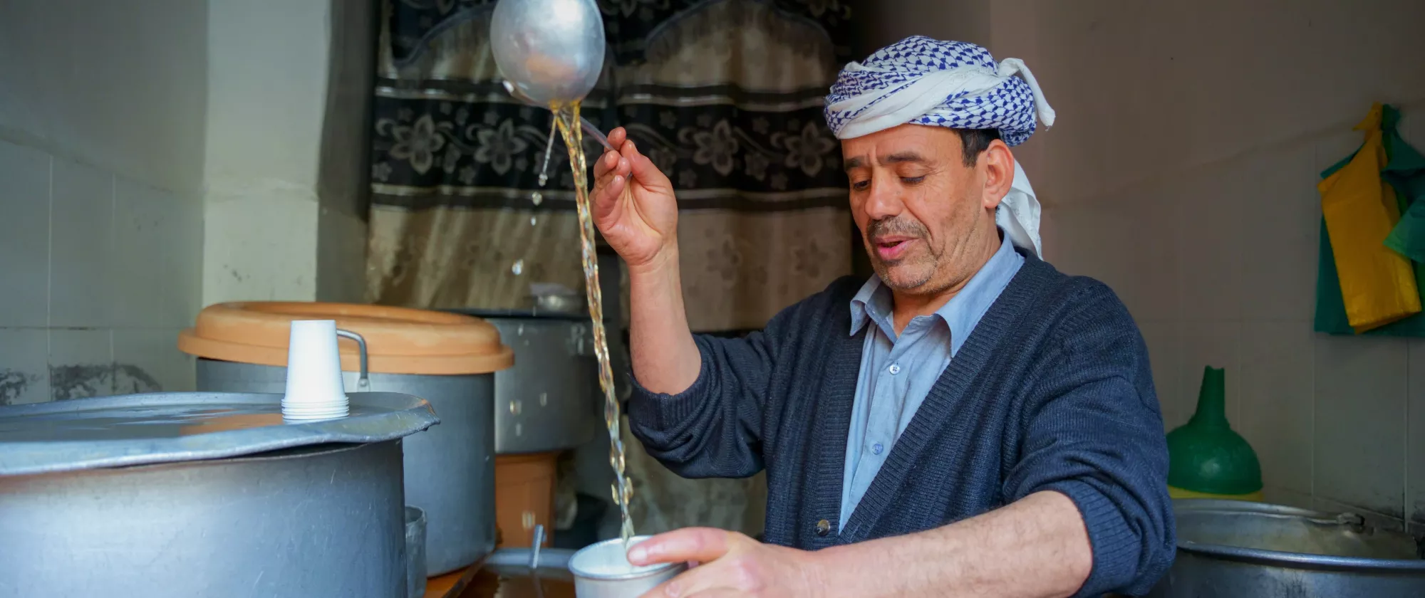 man pouring juice. 