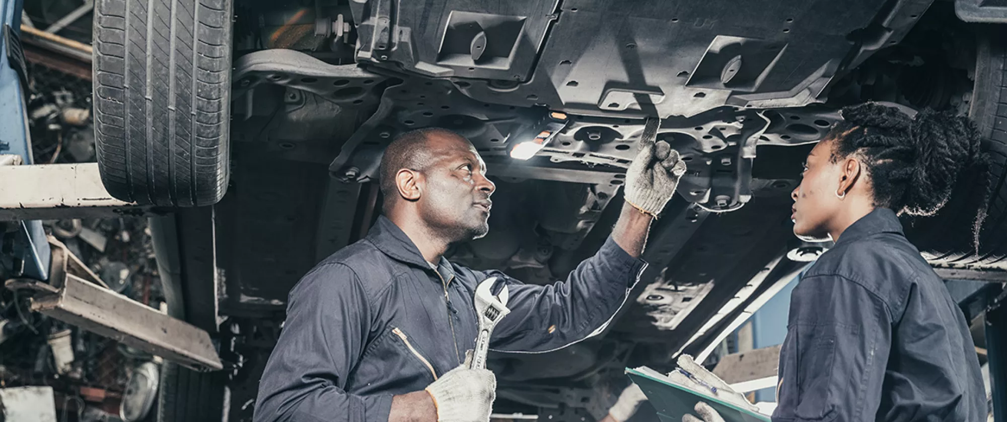 Mechanic mentor supervises trainee