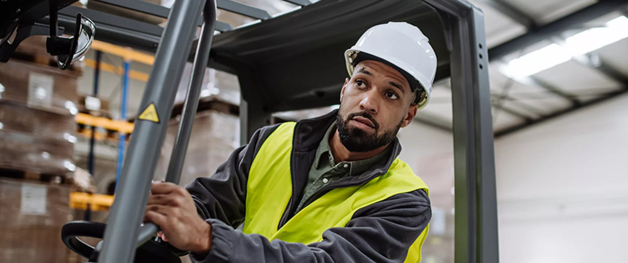 Warehouse forklift worker preparing stock for delivery