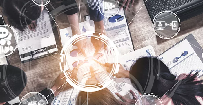 People around a table with modern graphic related to business startup