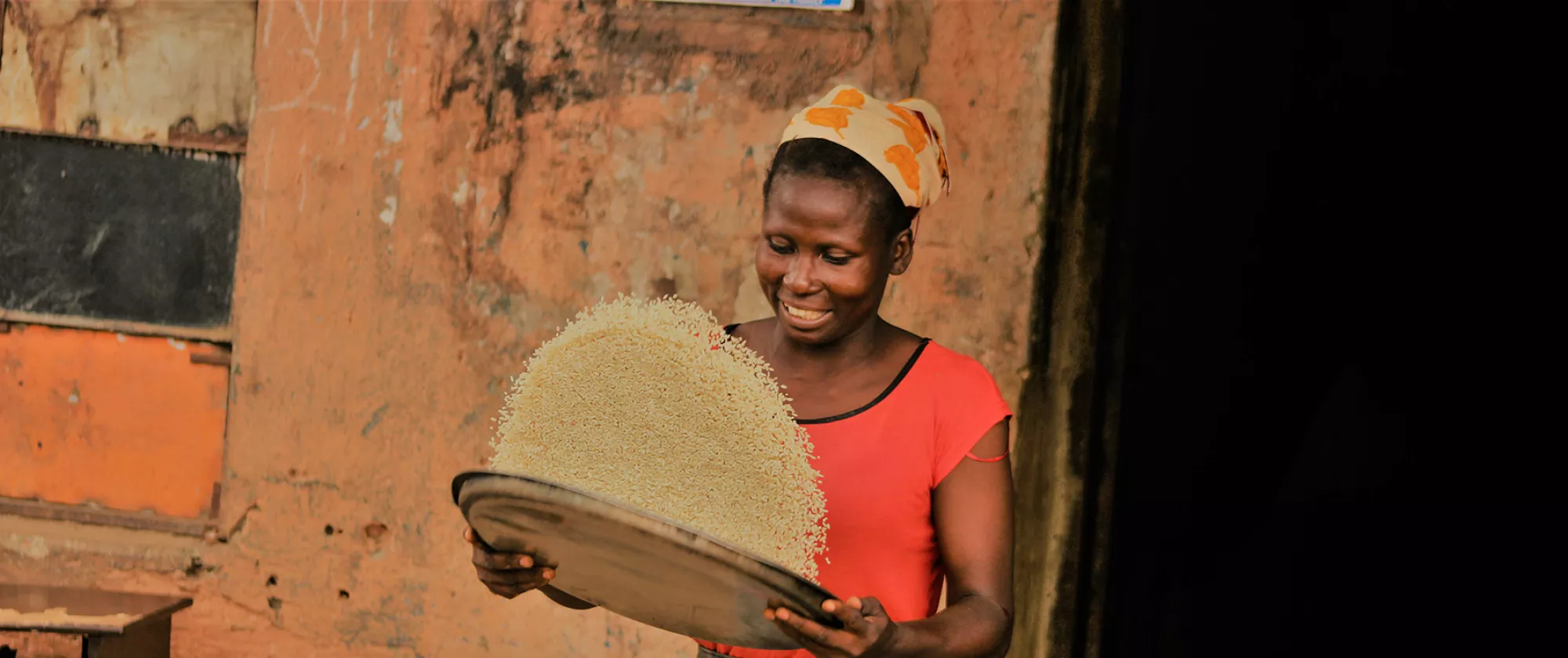 Photo of woman drying some grain