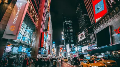 Photo of a busy commercial street at night.