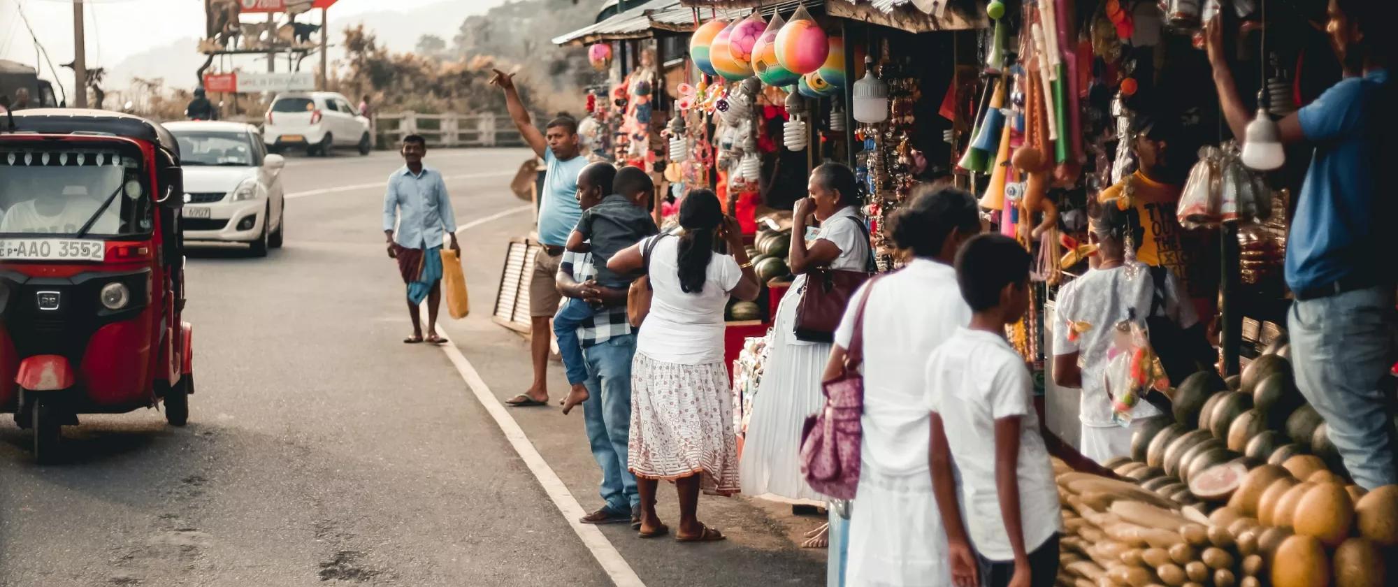 crowds at a stretch of street side shops