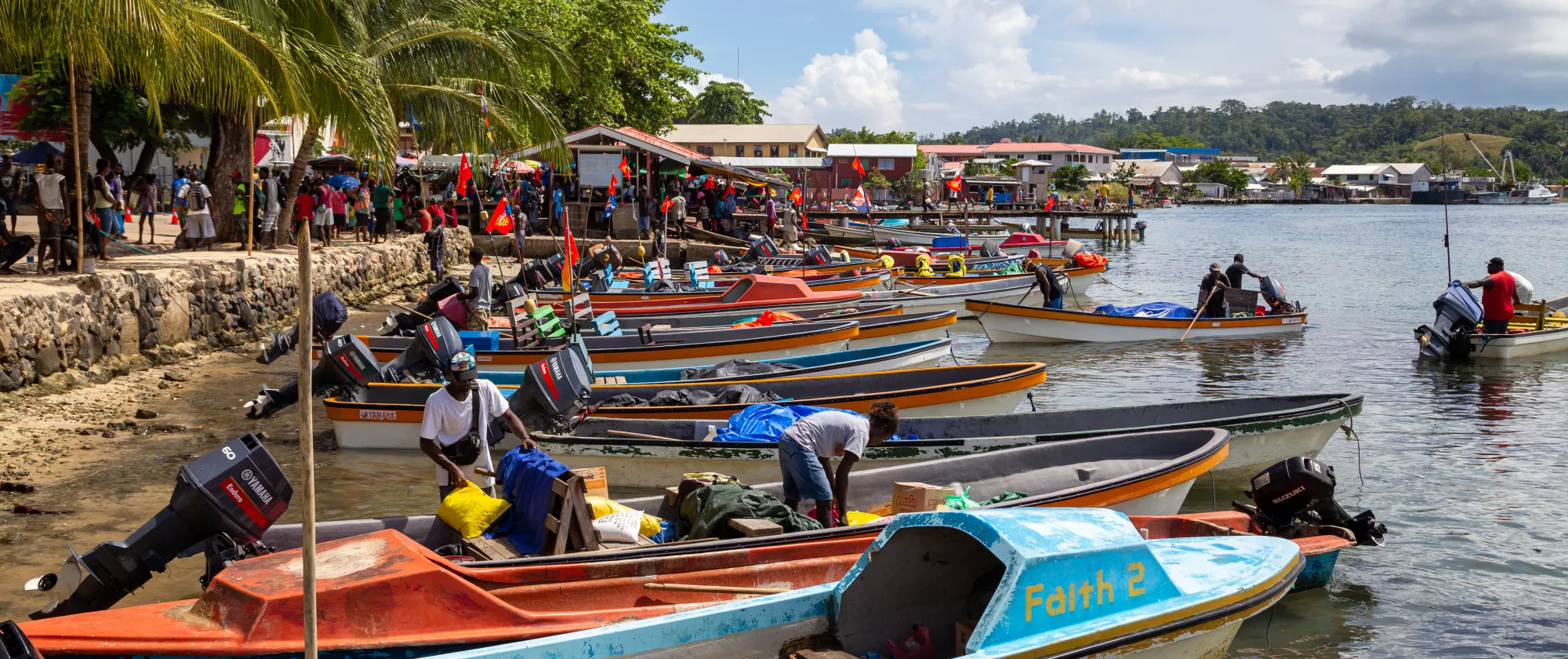 Boats moored along the shoreline in front of Gizo Market in the Solomon Islands.