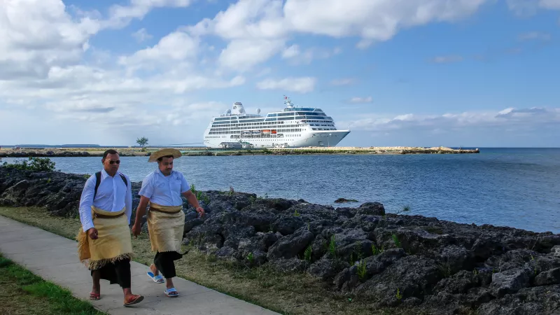 Men walk at the waterfront on November 11, 2013 in Nuku'alofa on Tongatapu island, Tonga.