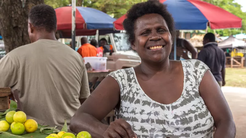 Solomon Islands woman sells lemons at the Gizo Fish Market.