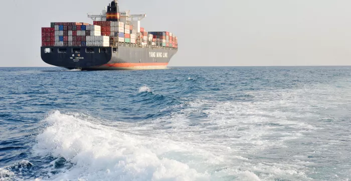 A view of the Chinese ship the "Y M Orchid" leaving the harbour. Port of Genoa, Italy.