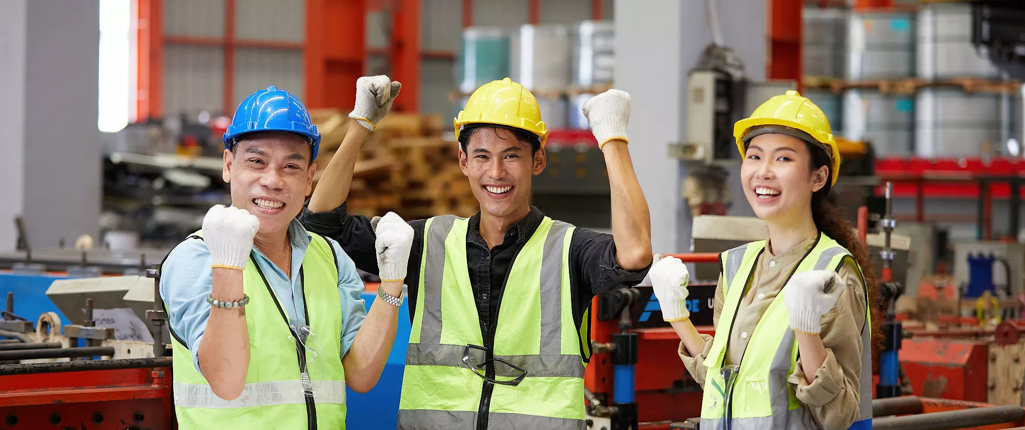 Workers team raise hand up for success work in the factory in Thailand