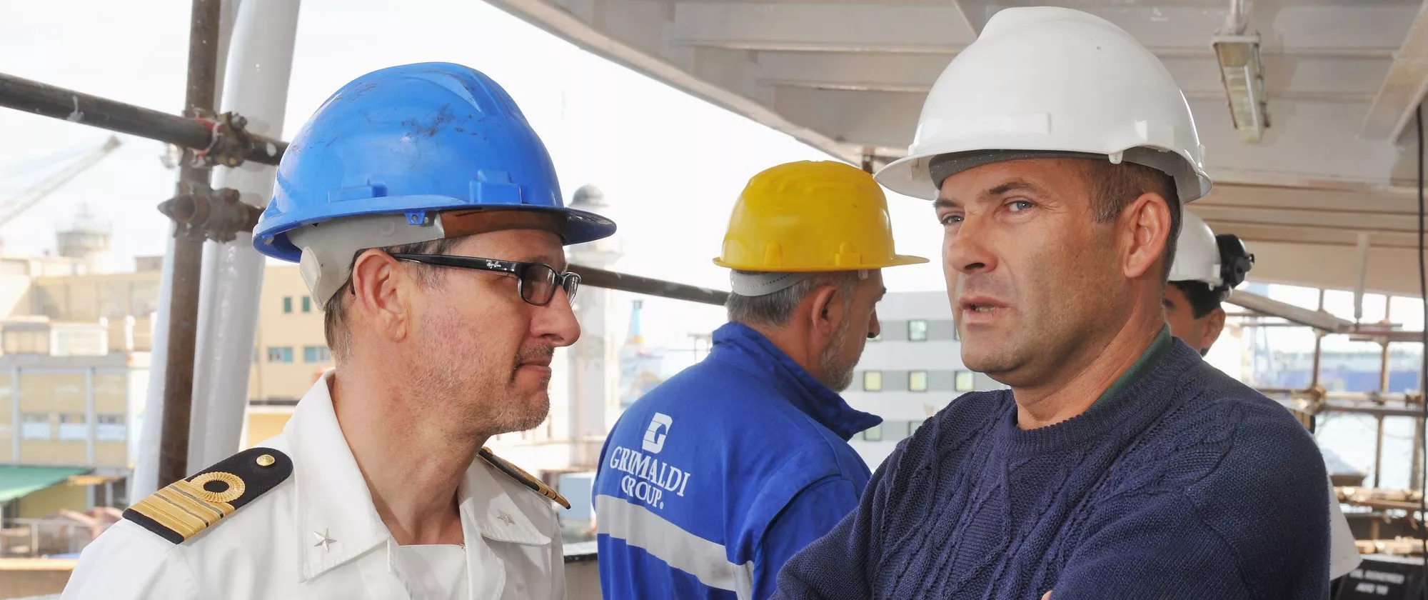 Workers onboard of a ship in the port of Genoa